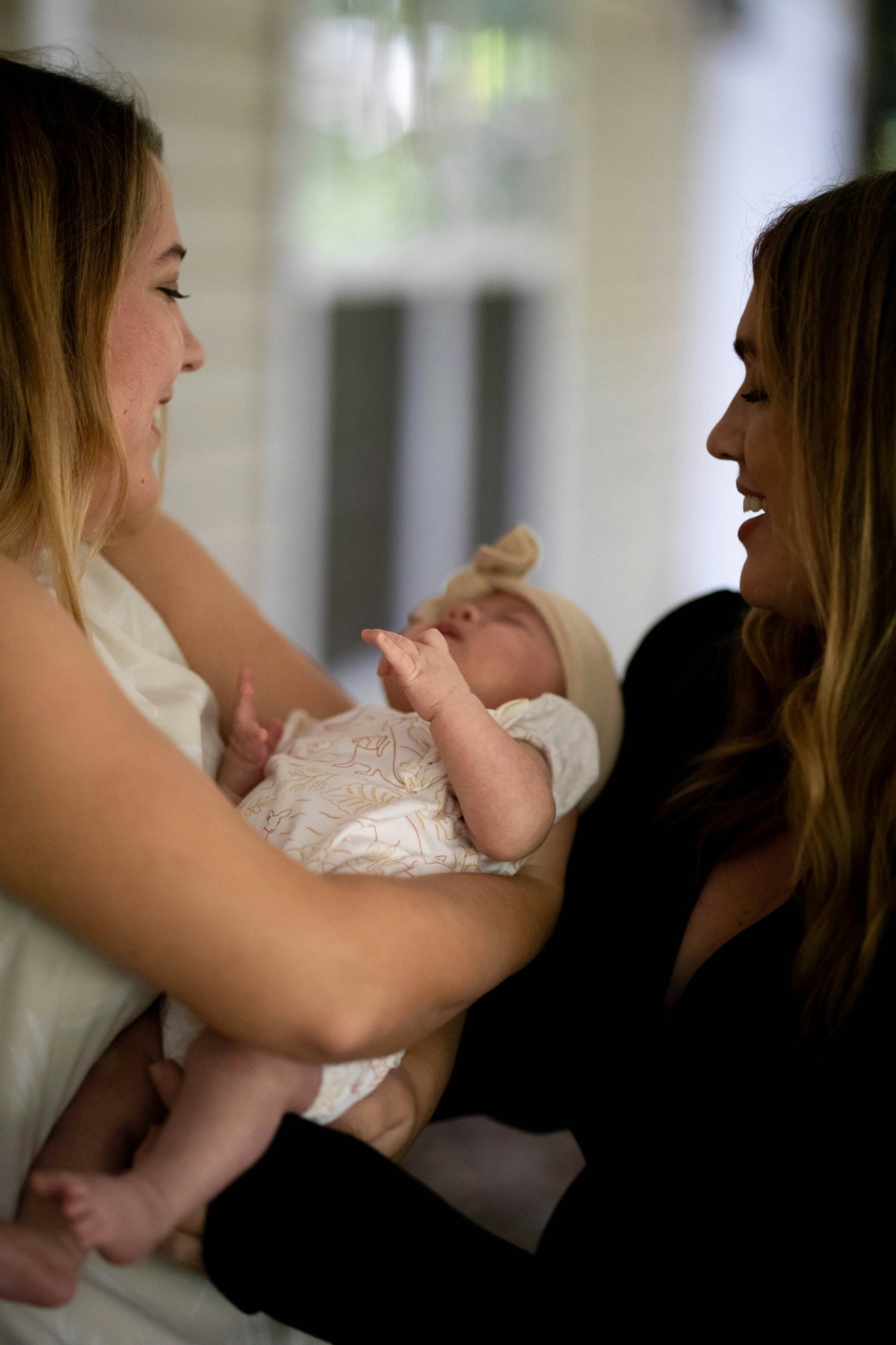 Parent resting at night while a caregiver looks after the newborn